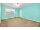 Bright bedroom with fresh blue walls, carpet, a ceiling fan, and a bright window at 128 Lacona Trce, Mooresville, NC 28115
