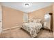 Cozy bedroom featuring neutral walls, plush carpet, and a decorative floral comforter set at 128 Lacona Trce, Mooresville, NC 28115