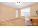 Bonus room featuring carpeted floors, a window, and desk area with storage at 128 Lacona Trce, Mooresville, NC 28115