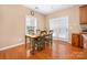 Cozy dining area with hardwood floors, four chairs, and a window at 128 Lacona Trce, Mooresville, NC 28115