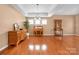 Bright dining room with hardwood floors, neutral walls, and natural light from three windows at 128 Lacona Trce, Mooresville, NC 28115