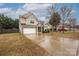 Two story home with attached garage, neutral siding, a well-manicured lawn, and a paved driveway in a suburban neighborhood at 128 Lacona Trce, Mooresville, NC 28115