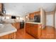 Bright kitchen with stainless steel appliances, center island, and hardwood floors at 128 Lacona Trce, Mooresville, NC 28115