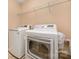 Convenient laundry room featuring a white washer and dryer, along with wire shelving for organized storage at 128 Lacona Trce, Mooresville, NC 28115