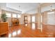 Expansive living room with gleaming wood floors, neutral paint, generous natural light, and versatile layout perfect for various uses at 128 Lacona Trce, Mooresville, NC 28115