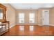 The well-lit living room features hardwood floors, neutral walls, and sunlit windows that creates a welcoming atmosphere at 128 Lacona Trce, Mooresville, NC 28115
