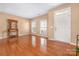 Welcoming living room features hardwood floors, neutral wall paint, natural light, and an inviting open layout at 128 Lacona Trce, Mooresville, NC 28115