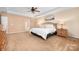 Spacious main bedroom with tray ceiling, fan, carpet flooring, and natural light at 128 Lacona Trce, Mooresville, NC 28115