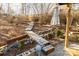 Landscaped backyard with wooded walkway, mature trees, and garden area at 152 Muskhogean Way, Mount Gilead, NC 27306