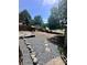 Backyard featuring rock landscaping, a small shed, wooden fence, and mature trees at 152 Muskhogean Way, Mount Gilead, NC 27306