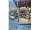 Cozy backyard deck with wooded walkway, quaint bench seating and colorful decor at 152 Muskhogean Way, Mount Gilead, NC 27306