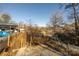 Wooded backyard featuring a gravel patio and surrounding trees at 152 Muskhogean Way, Mount Gilead, NC 27306