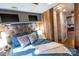 Comfortable bedroom features a grey headboard, wood paneling, and closet space at 152 Muskhogean Way, Mount Gilead, NC 27306