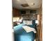 Cozy bedroom features wood paneling, a grey headboard, and natural light at 152 Muskhogean Way, Mount Gilead, NC 27306