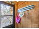 Coastal themed entryway featuring natural wood walls, decorative surfboard, and beach accessories at 152 Muskhogean Way, Mount Gilead, NC 27306