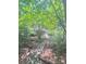 Exterior shot showing a wood path, wooded landscaping, and home at 152 Muskhogean Way, Mount Gilead, NC 27306