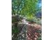 Exterior features a charming walkway and lush foliage leading to the property at 152 Muskhogean Way, Mount Gilead, NC 27306