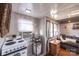 This simple kitchenette features natural light, an oven, a coffee maker and overlooks the living area at 152 Muskhogean Way, Mount Gilead, NC 27306