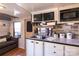The kitchenette has dark countertops, white cabinets and a view of the living area at 152 Muskhogean Way, Mount Gilead, NC 27306