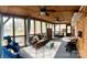 The screened porch has a wood ceiling, ceiling fans, seating and overlooks a lake view at 152 Muskhogean Way, Mount Gilead, NC 27306