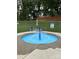 A community splash pad with seating and decorative umbrella at 152 Muskhogean Way, Mount Gilead, NC 27306