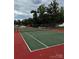 A fully fenced tennis court surrounded by mature trees at 152 Muskhogean Way, Mount Gilead, NC 27306