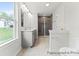 Bright bathroom featuring a double vanity and large walk-in shower with glass door at 156 Tangle River Dr # 35, Statesville, NC 28677