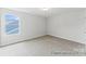 Bedroom featuring neutral carpet, natural light, and an entrance door at 156 Tangle River Dr # 35, Statesville, NC 28677