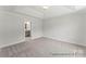 Bedroom with neutral carpet, tray ceiling, and view into the en suite bathroom at 156 Tangle River Dr # 35, Statesville, NC 28677