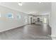 Open living space showcasing hardwood floors and leading to a modern kitchen with a central island at 156 Tangle River Dr # 35, Statesville, NC 28677