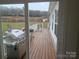 Back porch with a gas grill and a white railing at 1638 Bess Town Rd, Bessemer City, NC 28016