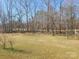 Grassy backyard with large trees on property line at 1638 Bess Town Rd, Bessemer City, NC 28016