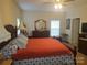 The bedroom is lit by a ceiling fan and natural light at 1638 Bess Town Rd, Bessemer City, NC 28016