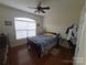 Bedroom with a bed, dressers, ceiling fan, hardwood flooring, and natural light at 1638 Bess Town Rd, Bessemer City, NC 28016
