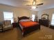 A large bedroom with a ceiling fan and large dresser set at 1638 Bess Town Rd, Bessemer City, NC 28016