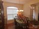 This dining room has a wooden table with a chandelier above it and hardwood flooring at 1638 Bess Town Rd, Bessemer City, NC 28016