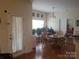 Bright dining area features wood floors, a table with four chairs, and a window filled with plants at 1638 Bess Town Rd, Bessemer City, NC 28016