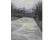 Long concrete driveway that approaches an iron gated entrance, with a stone privacy wall at 1638 Bess Town Rd, Bessemer City, NC 28016