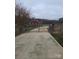 Exterior view of home with chainlink fence and gated entrance, framed by barren trees in winter at 1638 Bess Town Rd, Bessemer City, NC 28016