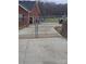 Driveway view of gate, brick home, and yard area at 1638 Bess Town Rd, Bessemer City, NC 28016