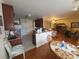 Open-concept living room with an eat-in kitchen, breakfast bar, and tile backsplash at 1638 Bess Town Rd, Bessemer City, NC 28016