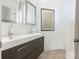 Bathroom featuring double vanity sinks with dark wood cabinets, and a large mirror at 1921 Union St, Charlotte, NC 28205