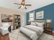 Bedroom featuring hardwood floors, neutral walls, a blue accent wall, and a white area rug at 1921 Union St, Charlotte, NC 28205