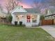 Charming home features a front porch, manicured lawn, and vibrant red door at 1921 Union St, Charlotte, NC 28205