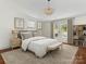 Bright main bedroom featuring hardwood floors, neutral walls, a ceiling fan, and access to the pool area at 1921 Union St, Charlotte, NC 28205