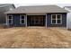Backyard featuring a navy blue exterior, covered patio, and an unfinished grass area at 2036 Skyhawk Dr, York, SC 29745