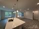 Open-concept kitchen featuring a large island with stone countertops at 2036 Skyhawk Dr, York, SC 29745