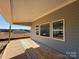 Covered back porch with concrete flooring and three windows at 2211 Camber Dr # Cwo0103, Gastonia, NC 28054