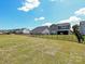 Spacious, grassy backyard enclosed by a black metal fence with multiple houses in view at 2211 Camber Dr # Cwo0103, Gastonia, NC 28054