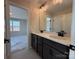 Bathroom featuring double sink vanity with stylish fixtures, large mirror and tile flooring at 2211 Camber Dr # Cwo0103, Gastonia, NC 28054